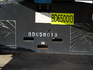 Yellow reflective sticker showing the unit number on machine chassis