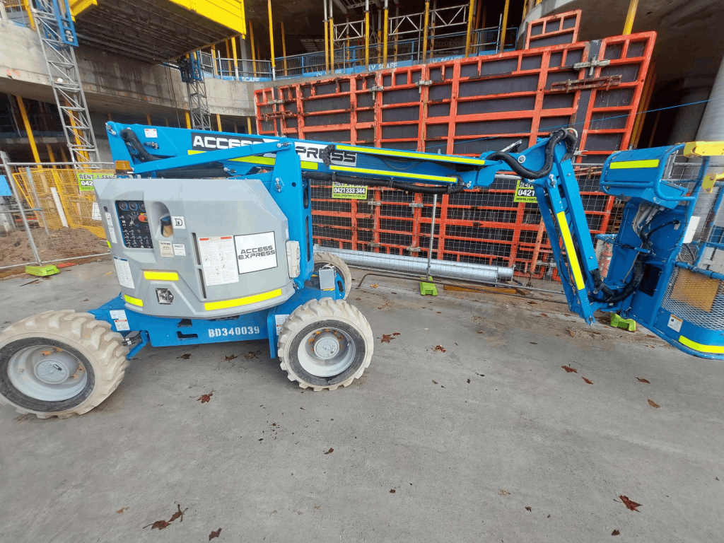 Access Express Genie Boom Lift Z34 in Front of Construction on Site