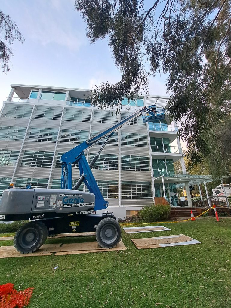 Access Express Genie Boom Lift on Site next to Construction Site