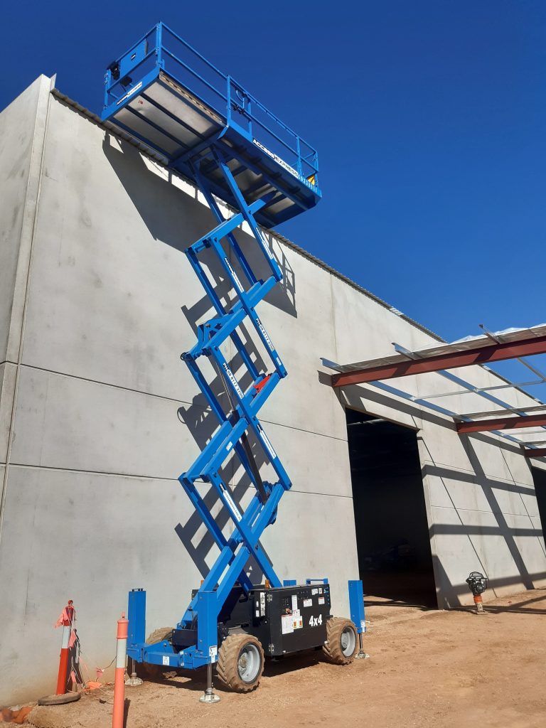 Access Express Genie Scissor Lift on SIte Next to Construction Building